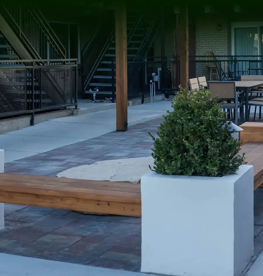 Finished commercial courtyard with hardscape, planters, and custom seating