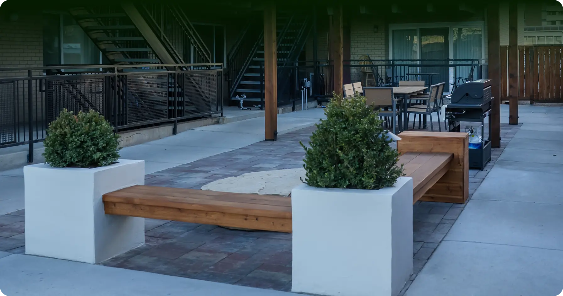 Finished commercial courtyard with hardscape, planters, and custom seating
